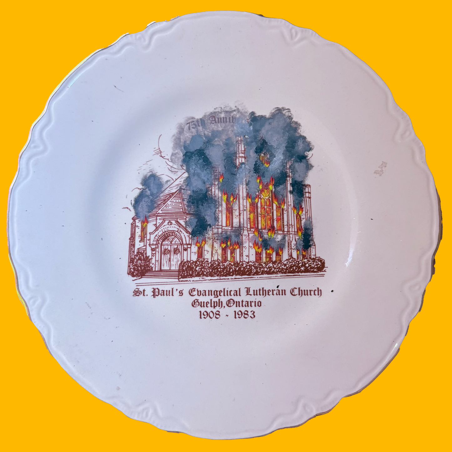 Decorative plate with a burning church illustration and text on a yellow background