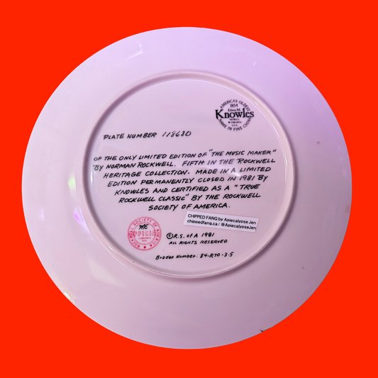 Back of a decorative plate with text and a logo describing the original plate. Orange background.