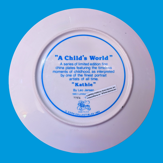 The back side of a decorative plate describing the original painting. 