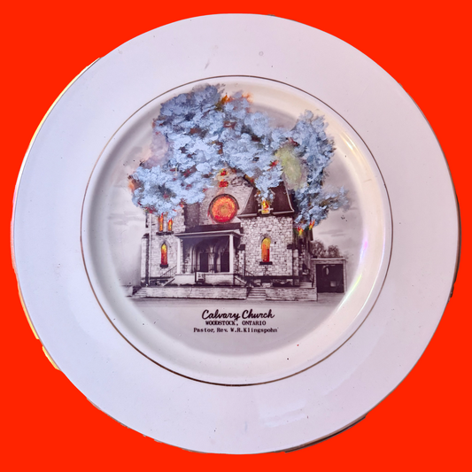 Decorative plate with a  burning church illustration on an red background