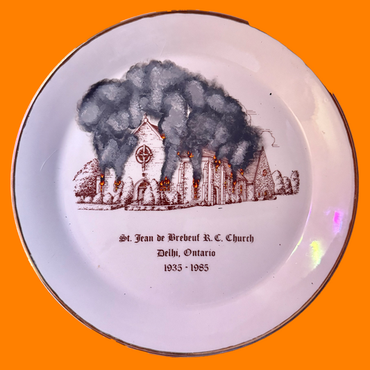 Decorative plate with a burning church illustration and text on an orange background