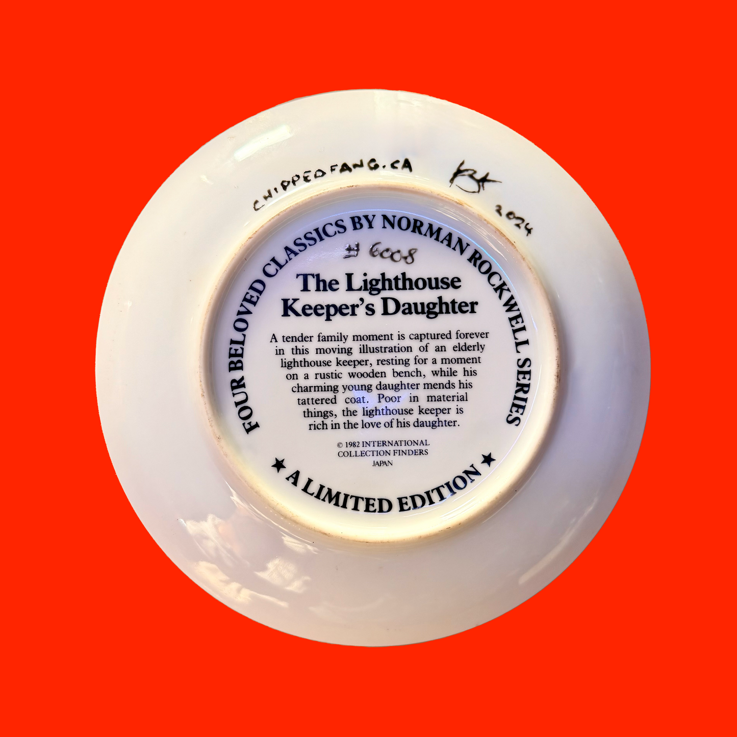 White back of a decorative plate with text on a red background